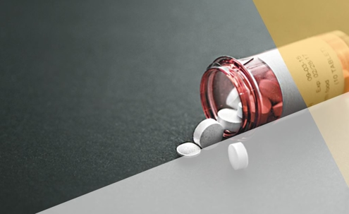 painkiller pills falling out of bottle