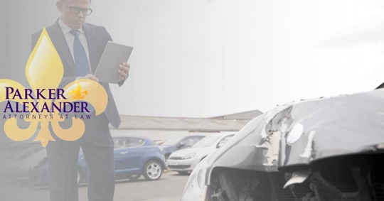 insurance adjuster taking photos of car accident damage