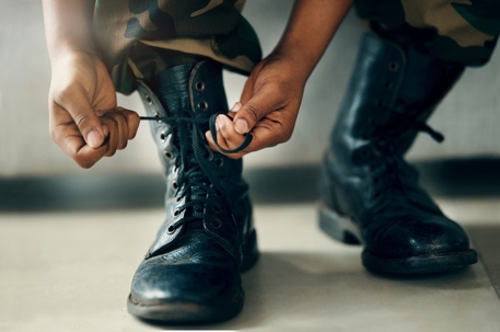 Military member putting on boots