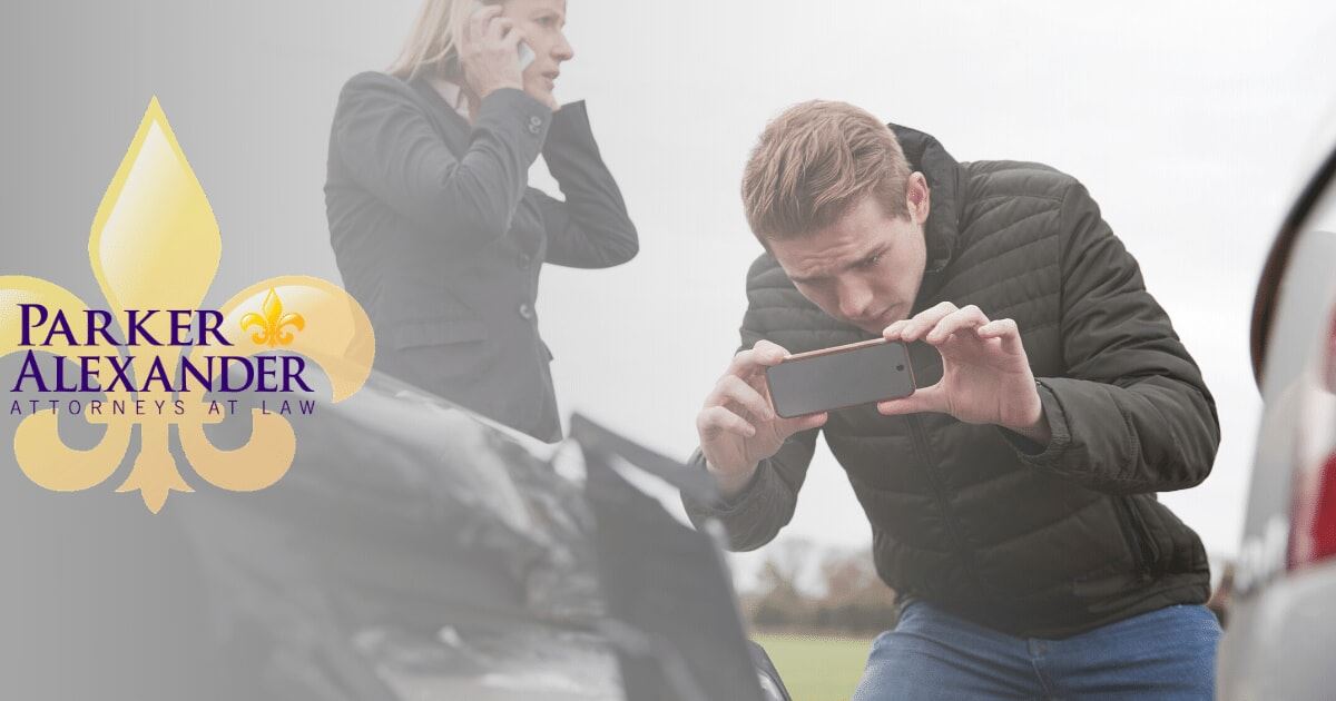 man taking photo of damage after an accident