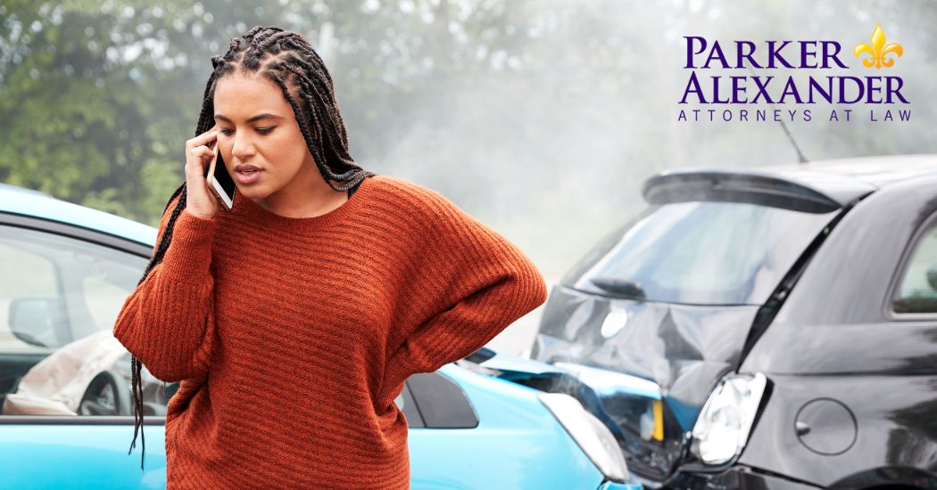 woman talking on the phone beside a car wreck